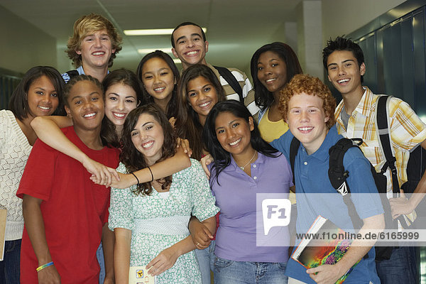 Group of multi-ethnic teenagers in school hallway