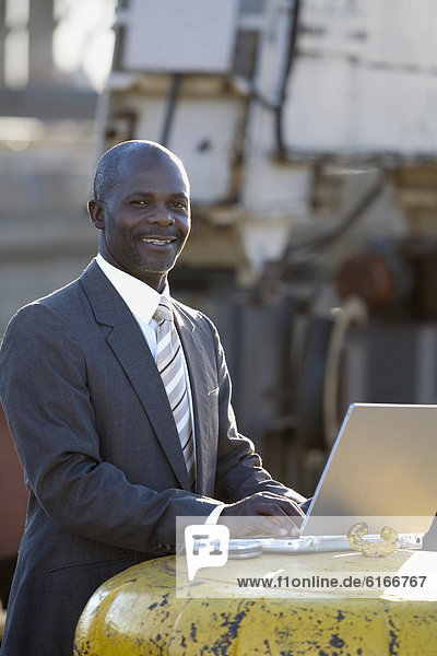 African American businessman typing on laptop