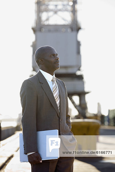 African American businessman holding laptop