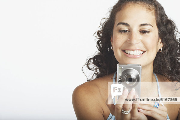 Young woman using a digital camera