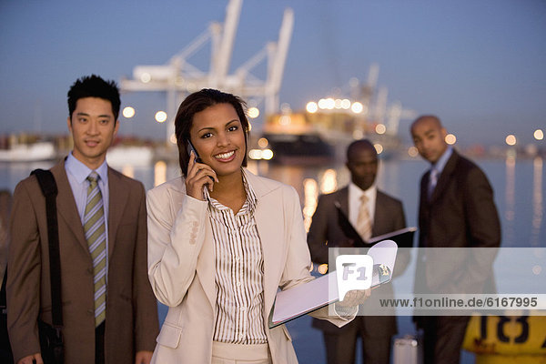 Multi-ethnic businesspeople in front of water