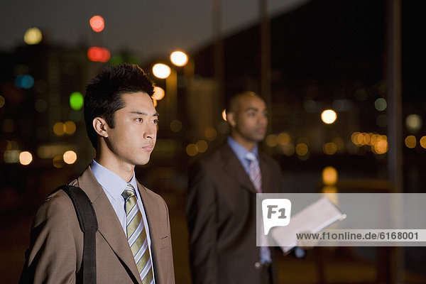 Multi-ethnic businessmen outdoors at night