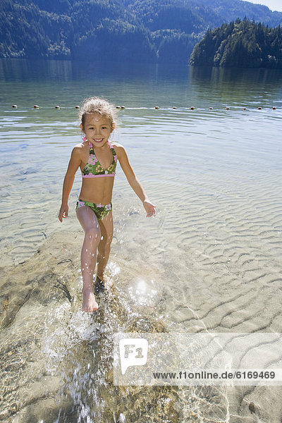 Asian girl splashing in lake