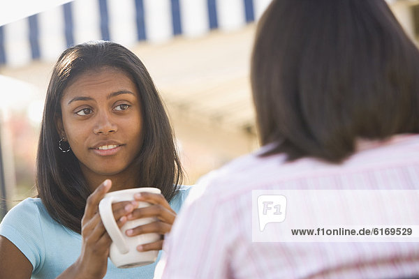 African teenaged girl talking to friend
