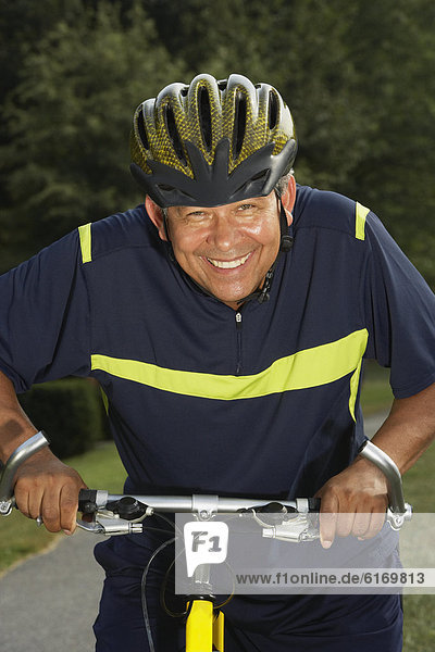 Hispanic man riding bicycle