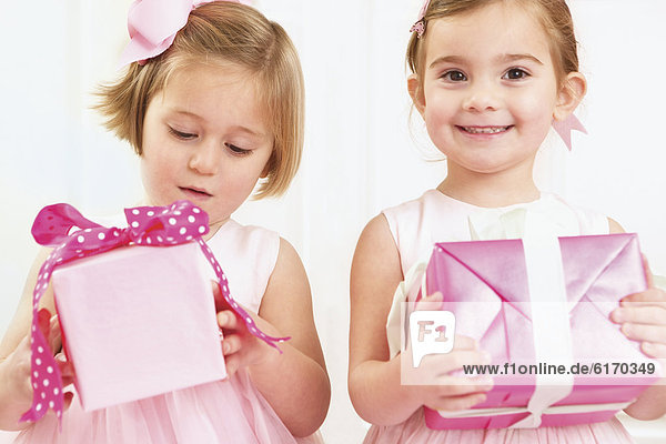 Young girls holding wrapped presents