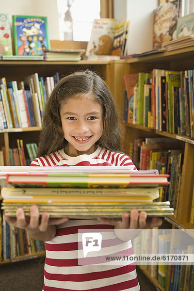 Pacific Islander girl holding library books