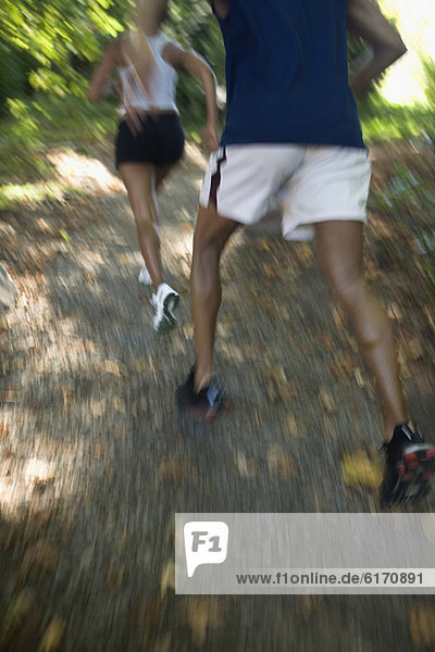 African couple running in woods