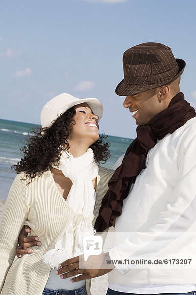 Multi-ethnic couple smiling at each other