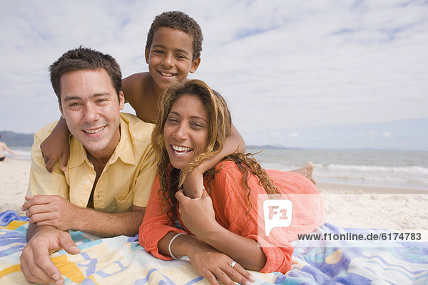 Family lying on the beach