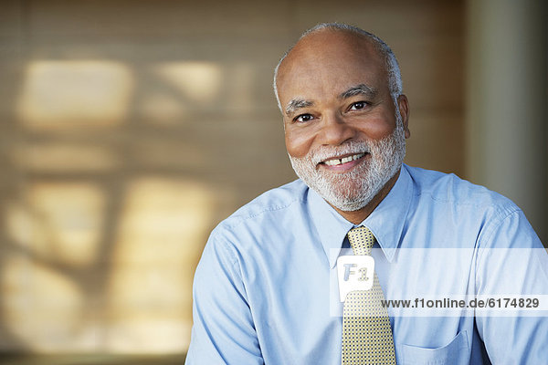 Senior African businessman smiling