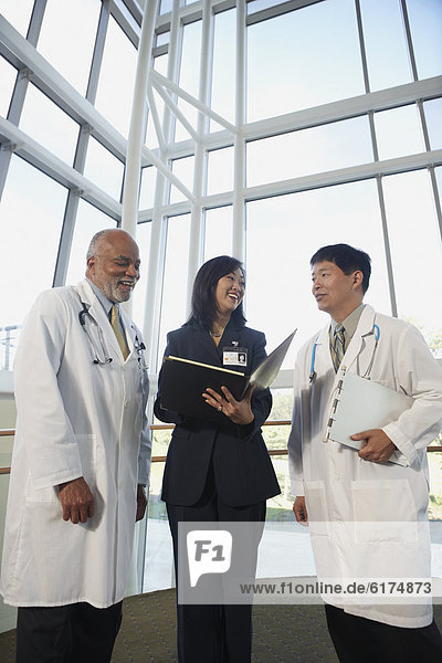 Businesswoman talking to two male doctors