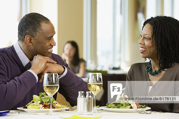 African American couple talking at restaurant