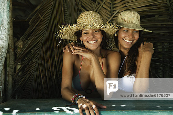 Hispanic women wearing straw hats