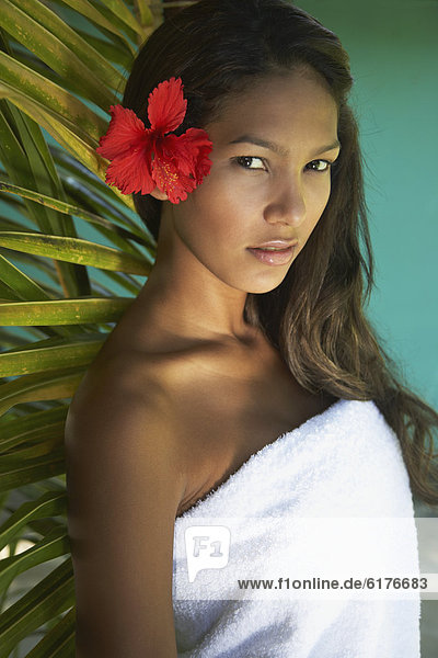 Hispanic woman with flower in hair