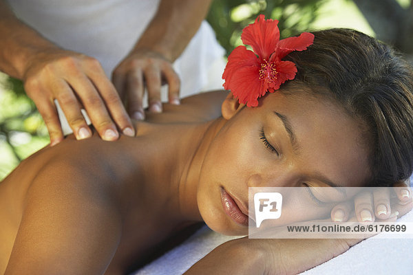 Hispanic woman receiving massage