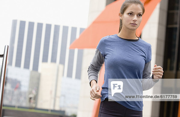 Hispanic woman running in urban area
