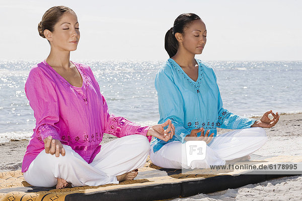Multi-ethnic women meditating