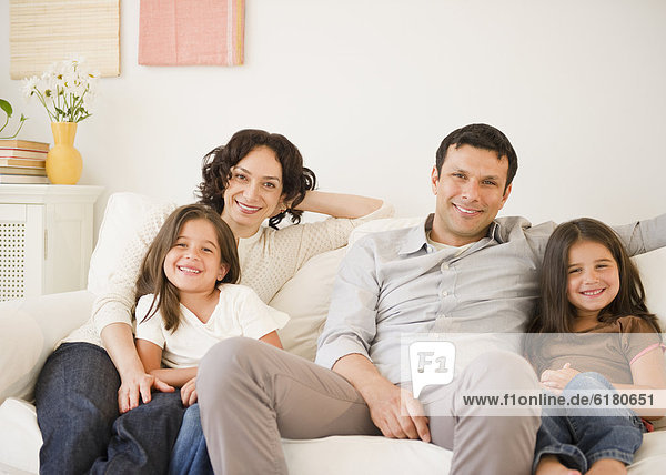 Happy family sitting on sofa together