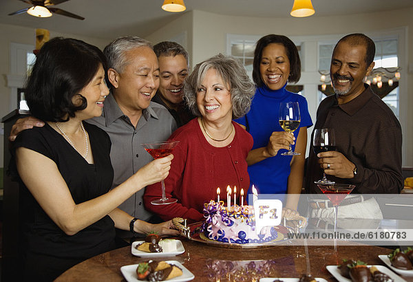Woman celebrating birthday with multi-ethnic friends