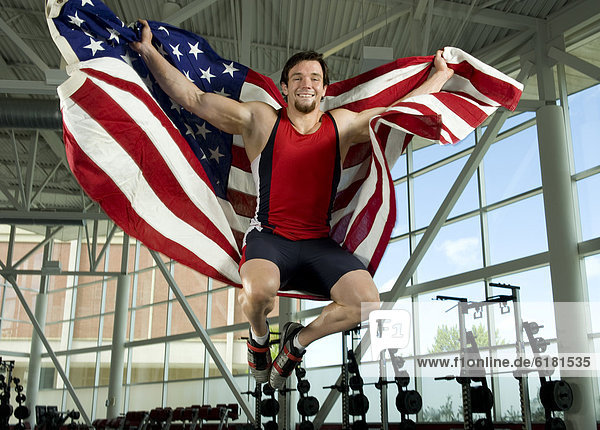 Caucasian athlete jumping with American flag
