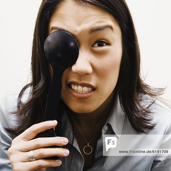 Asian woman covering eye