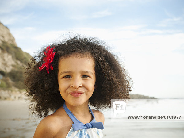 Smiling mixed race girl on beach