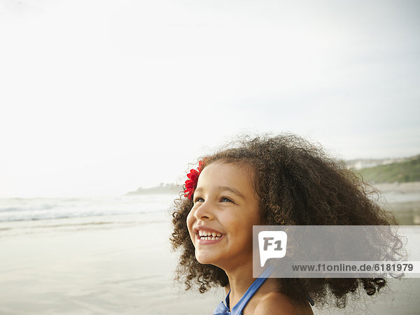 Smiling mixed race girl on beach
