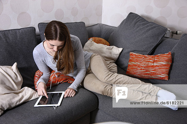 Girl playing at home with an iPad  tablet computer  wireless internet access