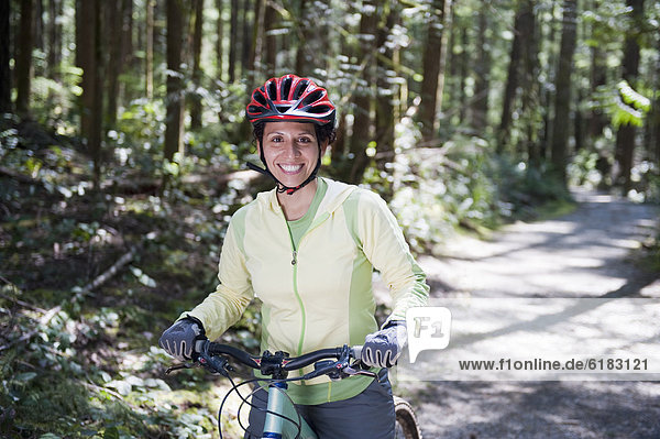 Hispanic woman riding mountain bike
