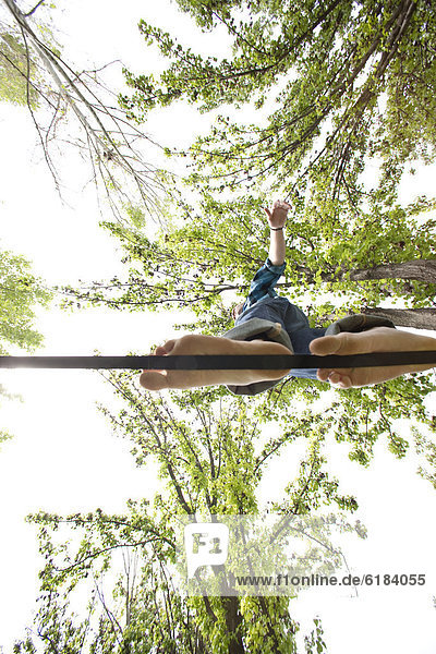 Caucasian man balancing on rope in park