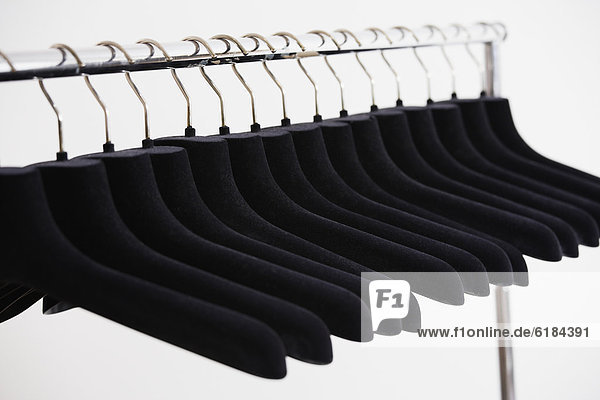 Row of empty clothing hangers on rack