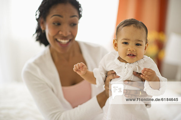 Mixed race woman holding baby