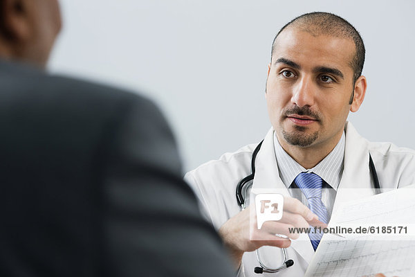 Lebanese male doctor talking with patient