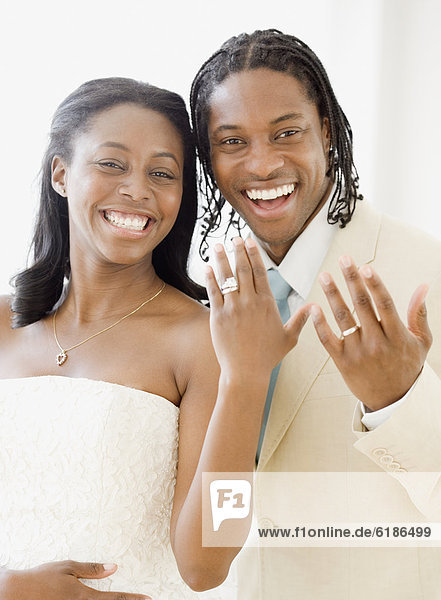 African bride and groom showing wedding rings