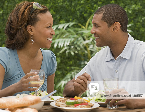African couple eating on patio