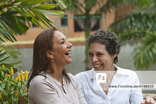 Hispanic women laughing together