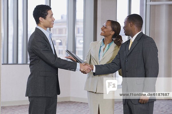 Multi-ethnic business people handshaking