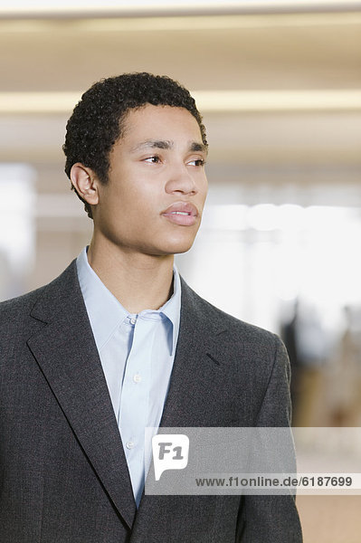 Mixed race businessman looking pensive