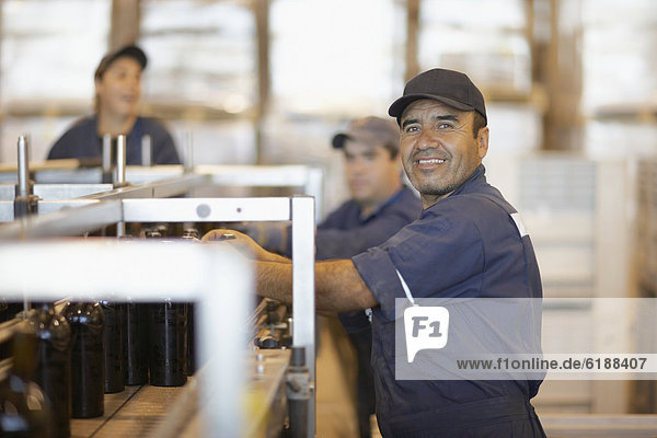 Hispanic man working in bottling factory