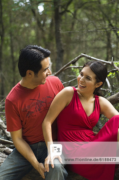 Hispanic couple sitting together outdoors