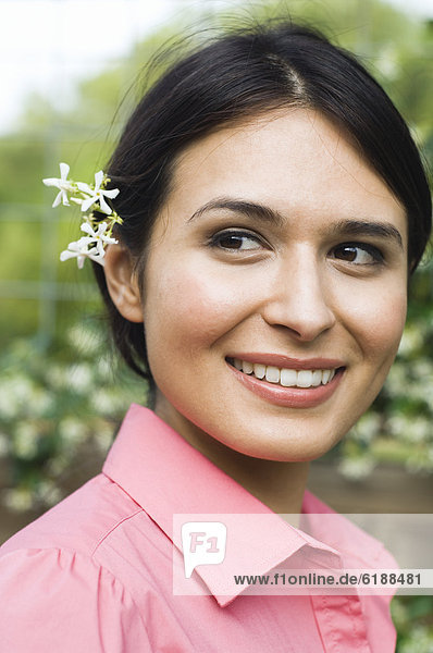 Hispanic woman with flower behind her ear
