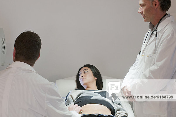 Doctors examining pregnant woman