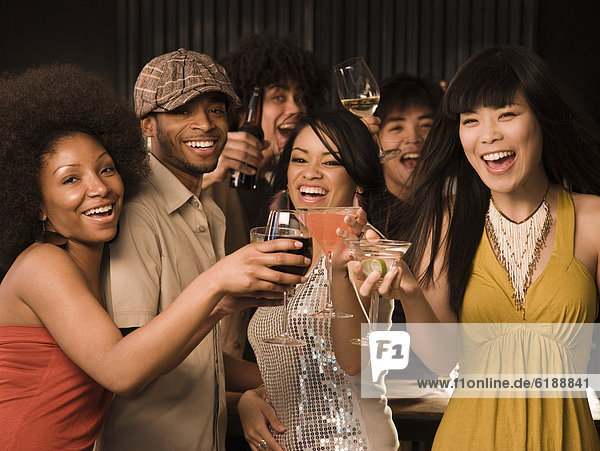Multi-ethnic friends drinking in nightclub