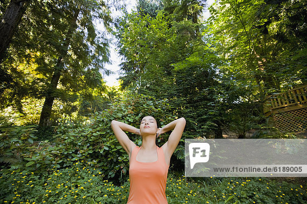 Hispanic woman stretching outdoors
