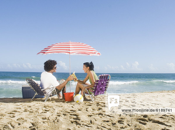 Multi-ethnic couple relaxing at beach