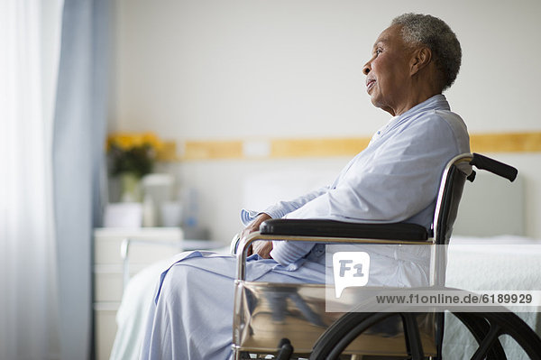 Black woman sitting in wheelchair in hospital