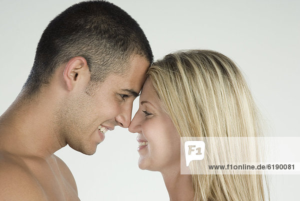 Smiling Hispanic couple face to face