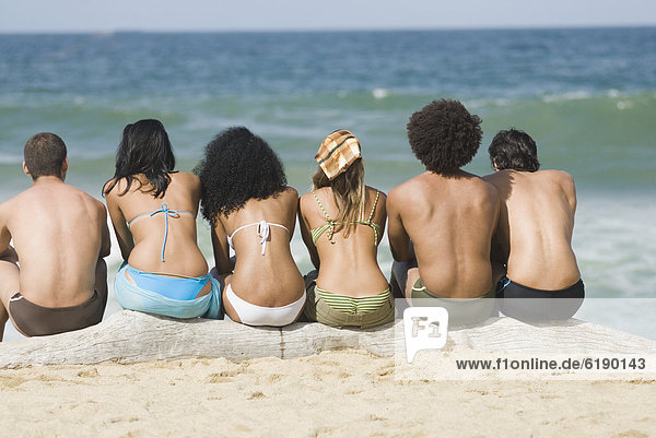 Multi-ethnic friends relaxing on beach