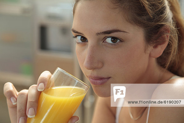 Caucasian woman drinking orange juice